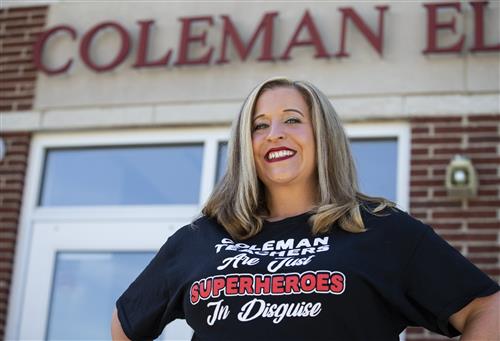 Principal Kelly Marotz  in front of building 